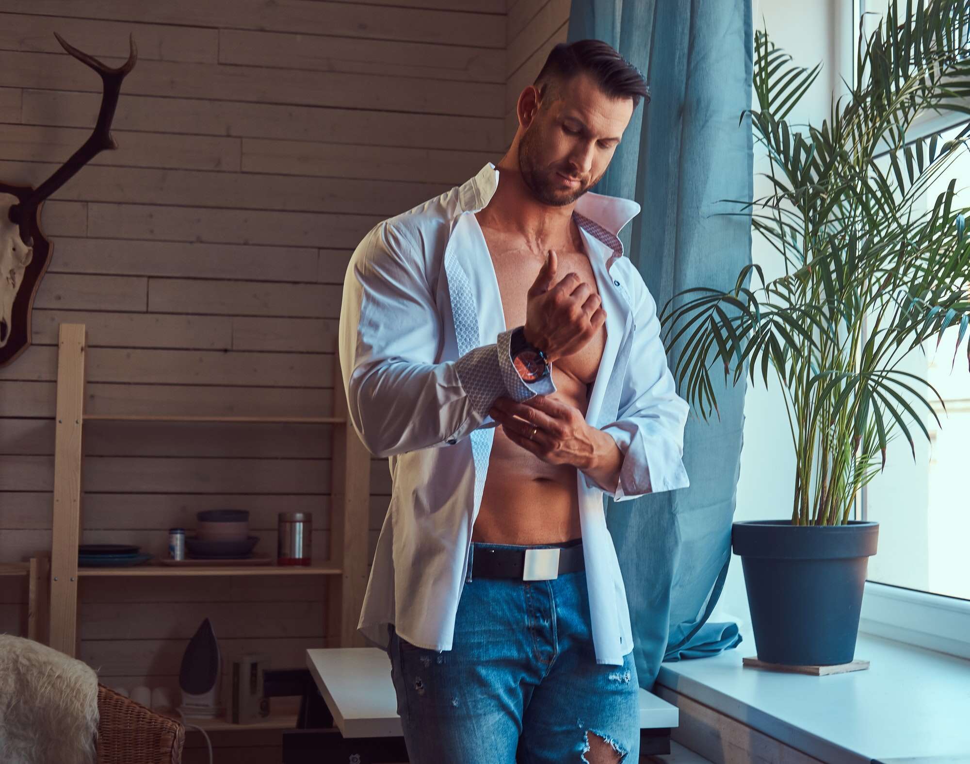 Portrait of a tall bearded male with a muscular body.